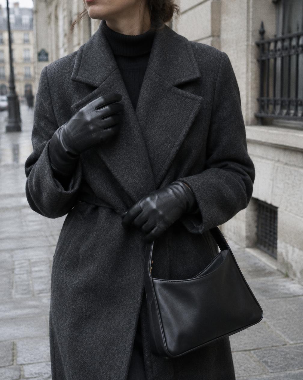 Black leather gloves worn beside the Seine